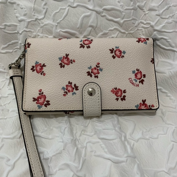 Coach Handbags - Coach floral tech wallet in excellent used condition